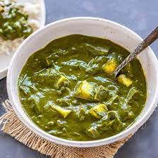 [Fresh spinach leaves are meticulously pureed and cooked to perfection, forming a velvety green base. Tender chunks of paneer are gently folded into the spinach puree, absorbing the essence of aromatic spices like cumin, coriander, and garam masala] Palak Paneer