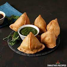 [The pastry, made from a thin layer of dough, wraps around a filling typically composed of spiced potatoes, peas, and sometimes, minced meat. Each samosa is a miniature work of art, expertly folded into a triangular shape and then deep-fried until it achieves a satisfying crunch] Samosa (2 pcs.)
