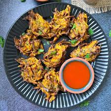 [These golden-brown fritters are a beloved snack in Indian cuisine, offering a delightful crunch on the outside and a soft, flavorful core. Made by batter-coating various ingredients such as potatoes, onions, spinach, or paneer] Pakode (15 pcs.)